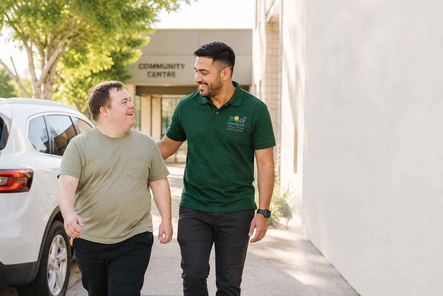 NDIS support worker walking with a participant near a community centre